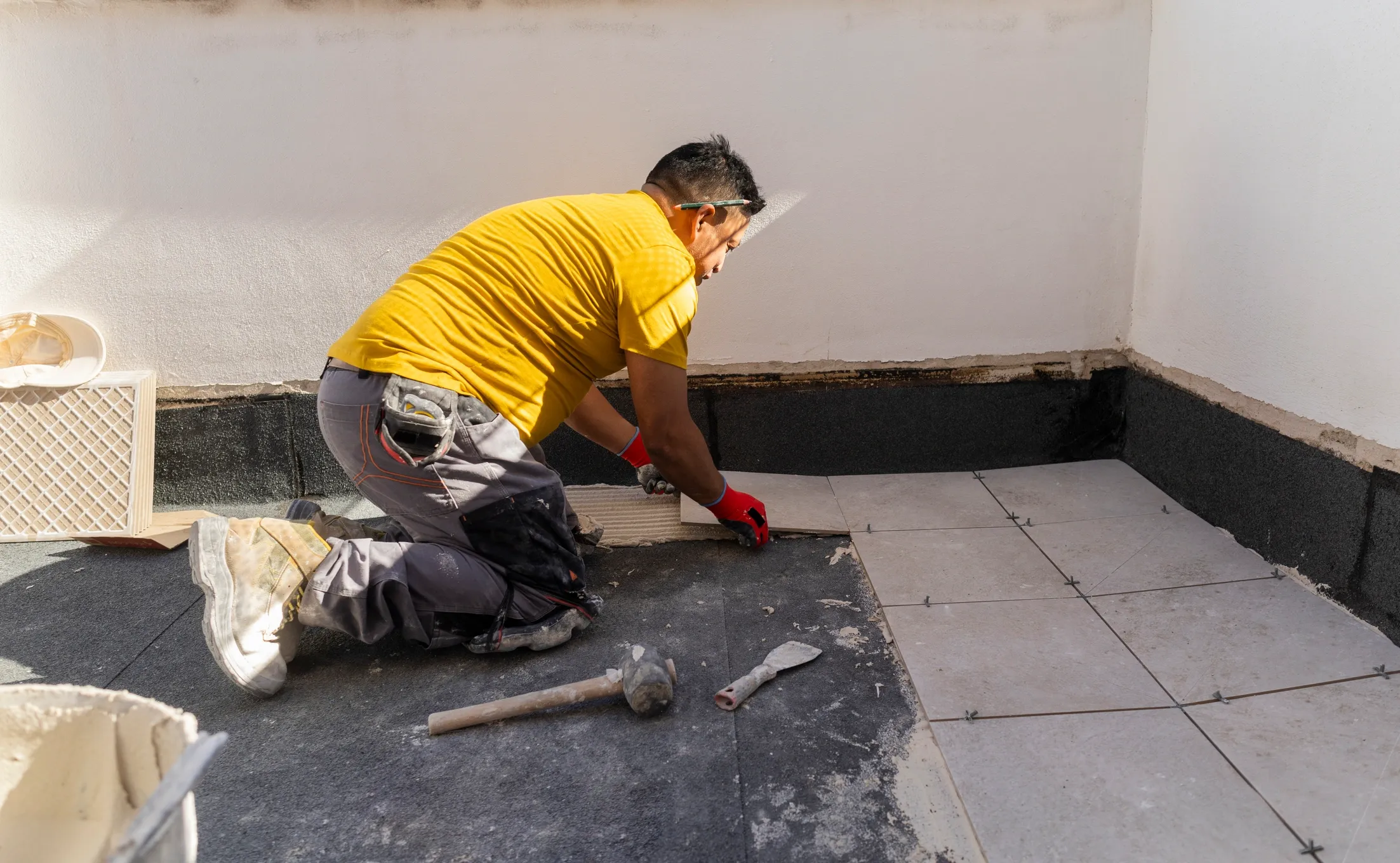 Tile installer working